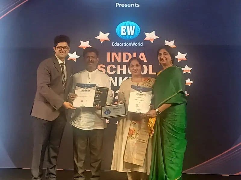 Eva leadership receiving an award on stage at the India School Merit Awards
