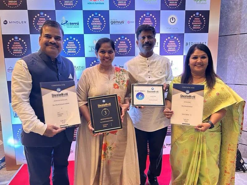 Eva leadership and teachers holding award plaques